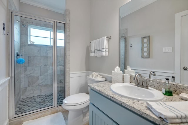 bathroom featuring walk in shower, ornamental molding, toilet, and vanity