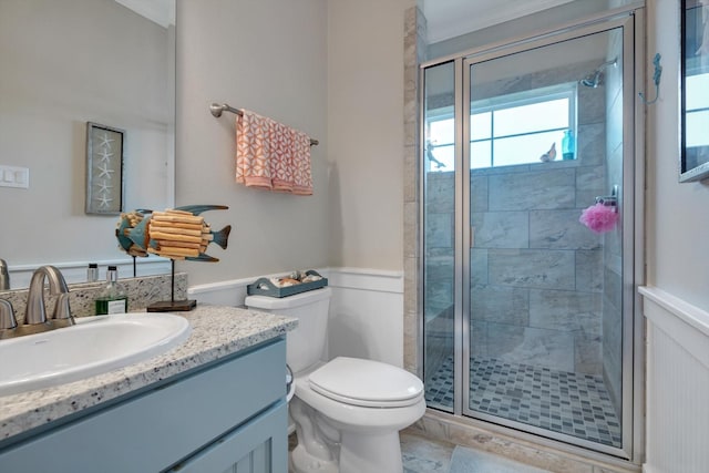 bathroom featuring vanity, toilet, and walk in shower