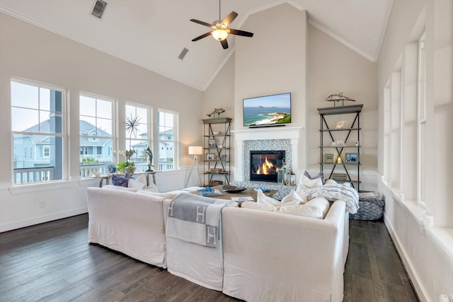 living room featuring crown molding, high vaulted ceiling, dark hardwood / wood-style flooring, ceiling fan, and a fireplace
