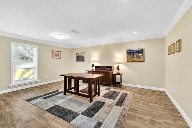 office with ornamental molding and light hardwood / wood-style floors