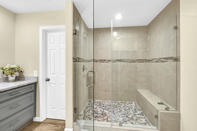 bathroom featuring vanity and an enclosed shower