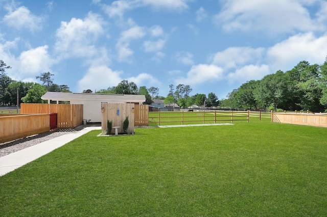 view of yard with a rural view