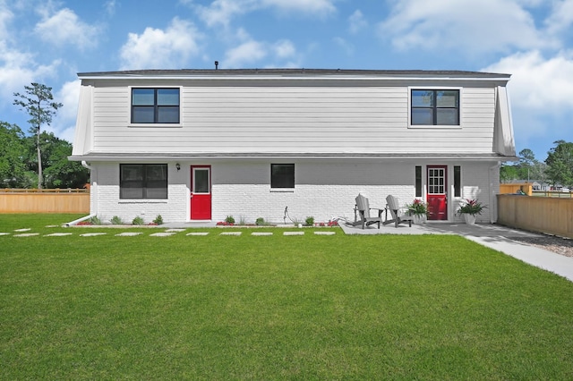 view of front of home featuring a front yard and a patio