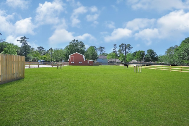 view of yard featuring an outbuilding and a rural view