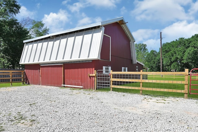 view of property exterior with an outbuilding