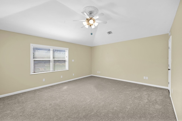 spare room featuring lofted ceiling, carpet floors, and ceiling fan