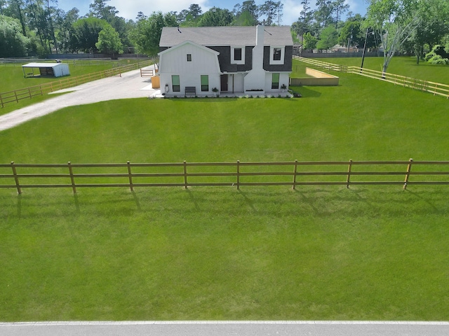 exterior space with a rural view and a yard