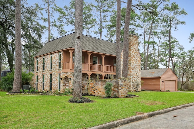 view of front of house with a shingled roof, a chimney, central AC unit, and a front lawn