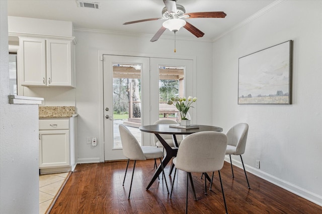 dining space featuring ornamental molding, ceiling fan, and light wood-type flooring