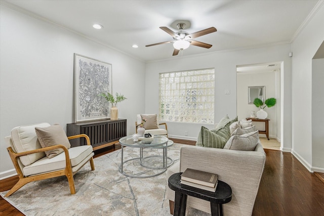 living room featuring ornamental molding, ceiling fan, and dark hardwood / wood-style flooring