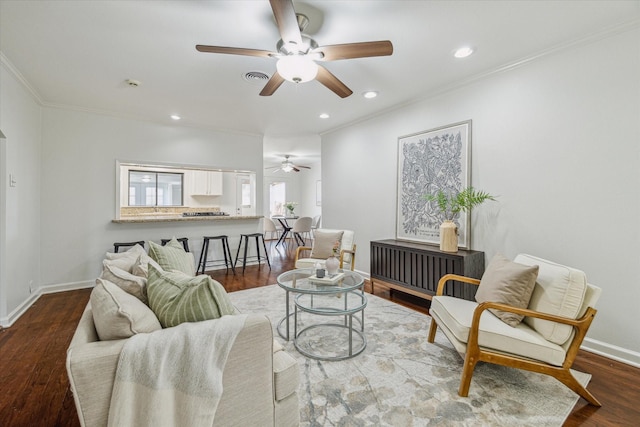 living room featuring wood-type flooring, ceiling fan, and crown molding