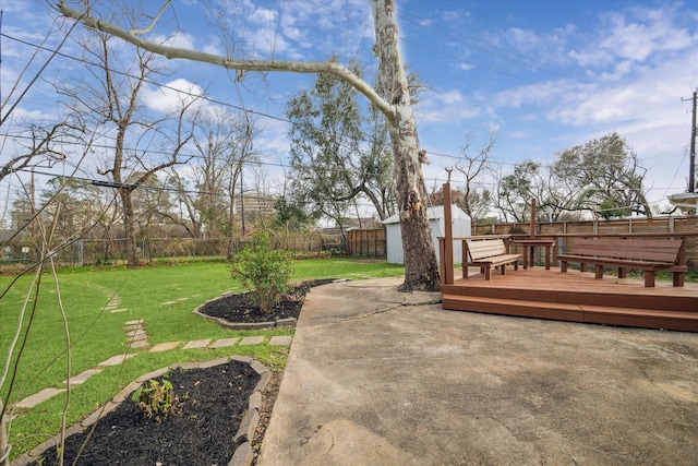 view of yard featuring a storage unit and a deck