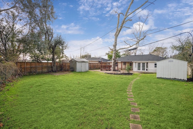 view of yard with a storage shed and french doors