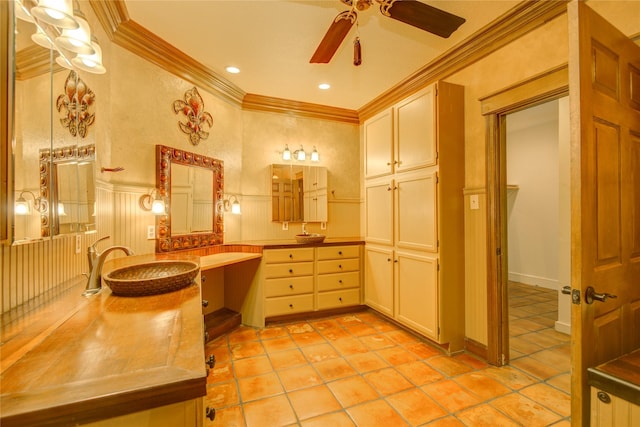 bathroom with tile patterned flooring, ornamental molding, vanity, and ceiling fan