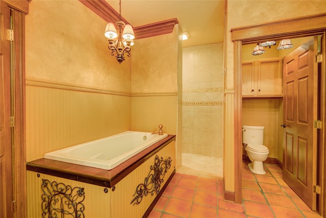 bathroom featuring tile patterned flooring, a bath, a notable chandelier, and toilet