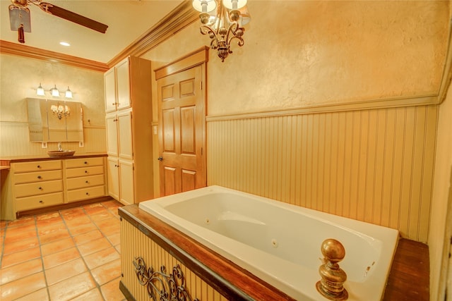 bathroom featuring a bathing tub, ceiling fan with notable chandelier, tile patterned flooring, ornamental molding, and vanity