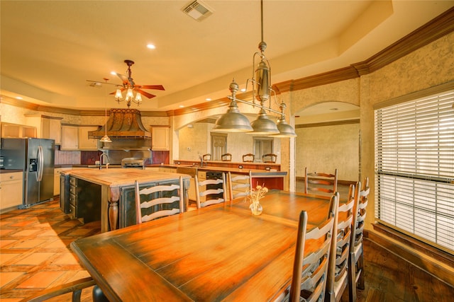 dining room featuring ornamental molding, sink, and ceiling fan