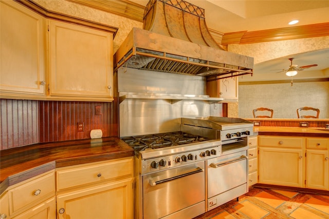 kitchen featuring wooden counters, ceiling fan, stainless steel range, custom range hood, and light brown cabinets