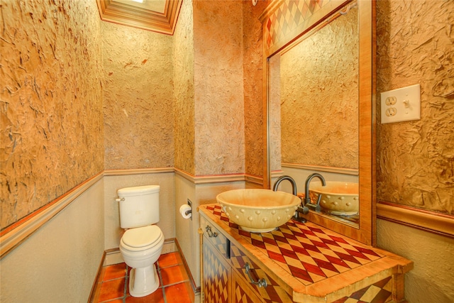 bathroom featuring vanity, toilet, and tile patterned flooring