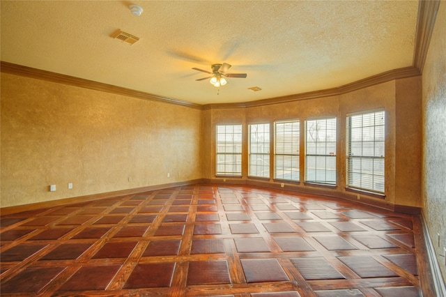 empty room with parquet floors, ceiling fan, ornamental molding, and a textured ceiling