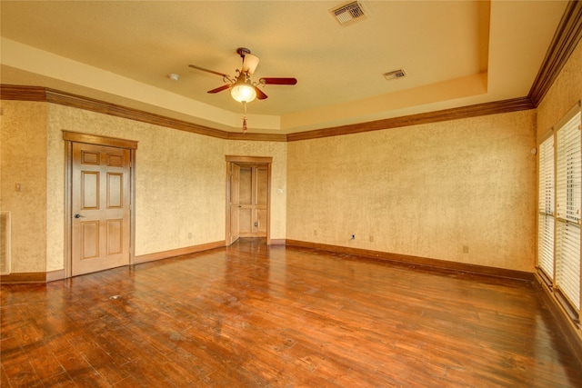 spare room featuring crown molding, hardwood / wood-style flooring, a raised ceiling, and ceiling fan