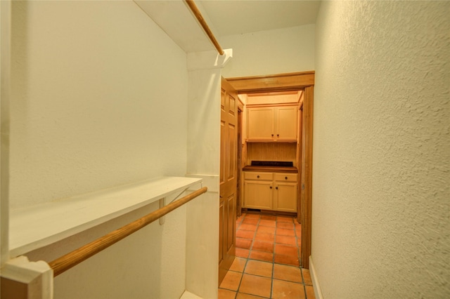 walk in closet with light tile patterned flooring