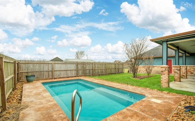 view of swimming pool with a yard and a patio area