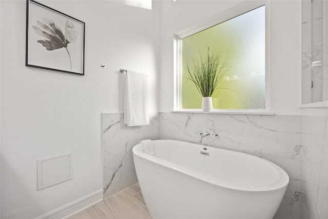 bathroom with a tub to relax in