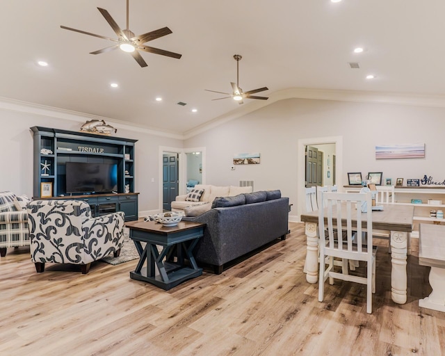 living room with crown molding, vaulted ceiling, ceiling fan, and light wood-type flooring