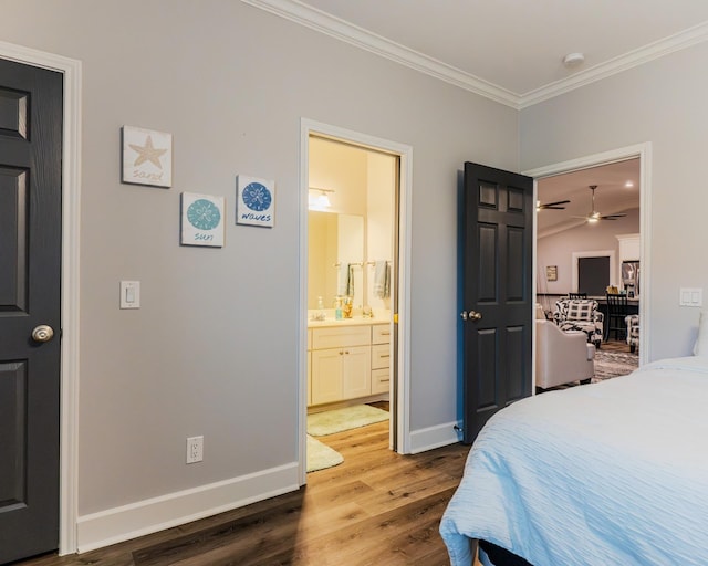 bedroom with wood-type flooring, crown molding, and ensuite bath