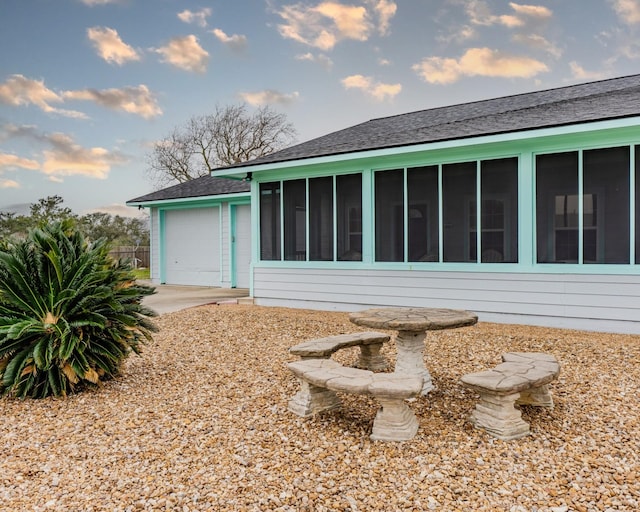 rear view of property featuring a garage