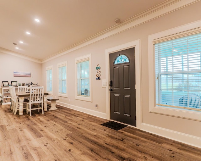 entryway featuring hardwood / wood-style flooring and crown molding