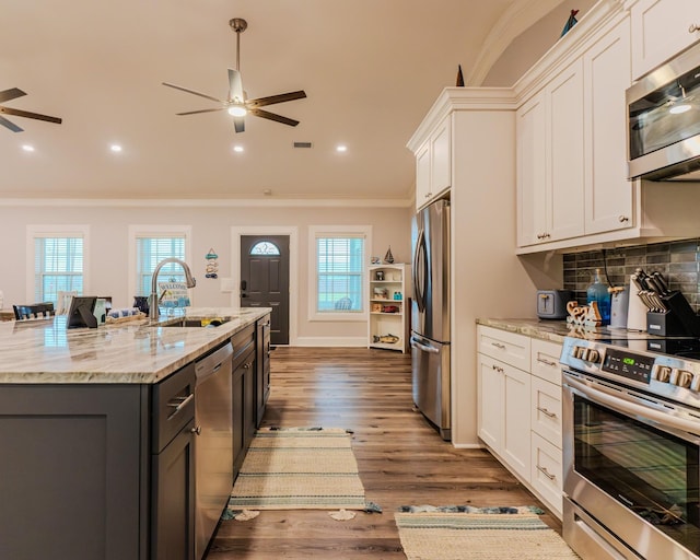 kitchen featuring light stone counters, appliances with stainless steel finishes, and white cabinets