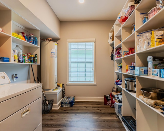 laundry room with dark hardwood / wood-style flooring, washer / dryer, and electric water heater