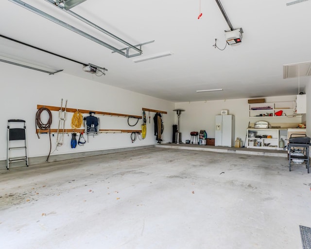 garage featuring a garage door opener and white refrigerator with ice dispenser