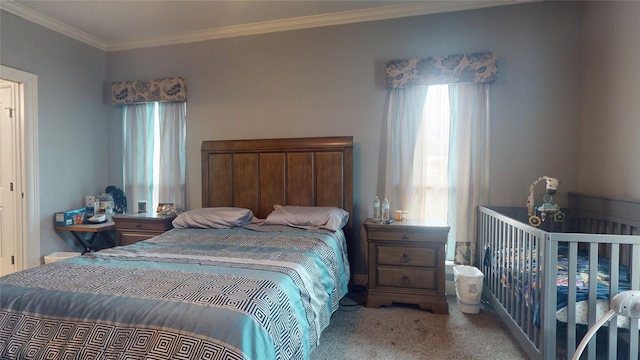 bedroom featuring crown molding, multiple windows, and carpet