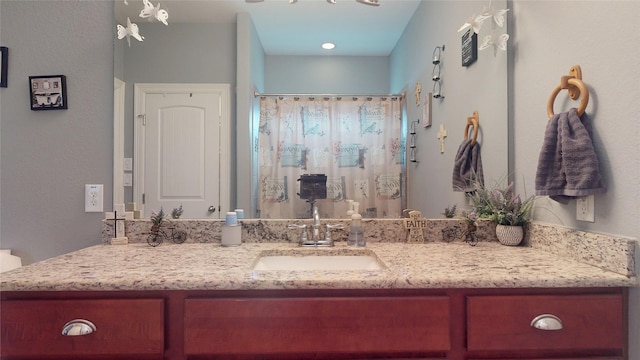 bathroom featuring vanity and a shower with shower curtain