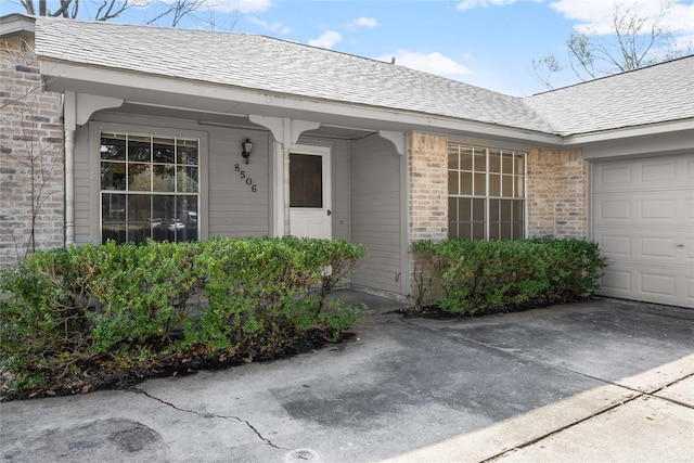 view of exterior entry featuring a garage