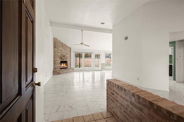 unfurnished living room with ceiling fan, high vaulted ceiling, and a brick fireplace