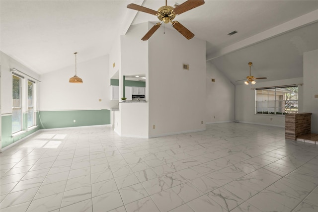 unfurnished living room with ceiling fan, beam ceiling, and high vaulted ceiling