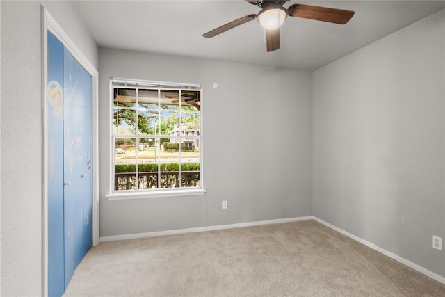 empty room with light carpet and ceiling fan