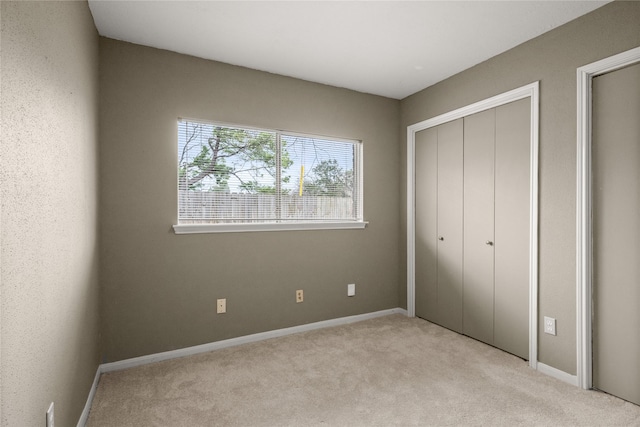 unfurnished bedroom featuring light colored carpet