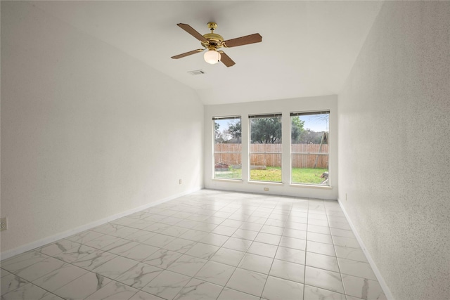 empty room with ceiling fan and vaulted ceiling