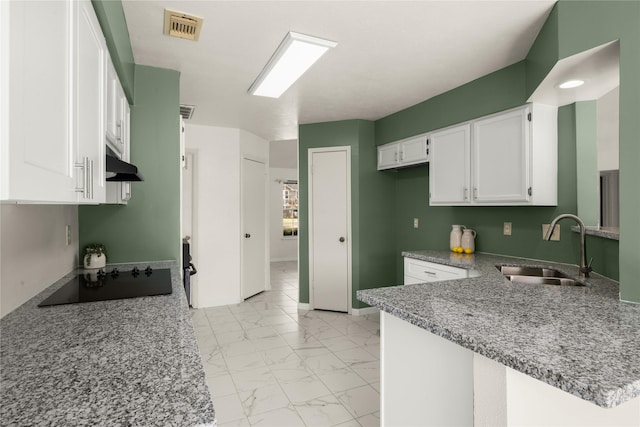 kitchen featuring sink, white cabinetry, light stone countertops, black electric cooktop, and kitchen peninsula