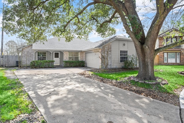 ranch-style home featuring a garage and a front yard