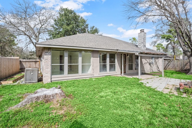 back of property with a patio, cooling unit, and a lawn