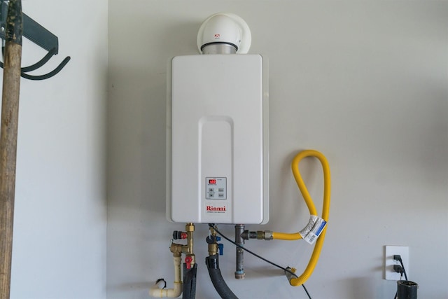 utility room with tankless water heater