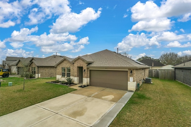 view of front of home featuring central AC unit, a garage, and a front yard