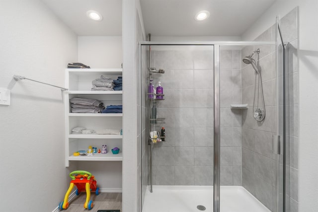 bathroom featuring a shower with shower door