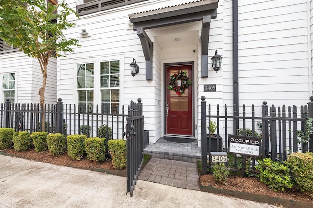 doorway to property featuring fence